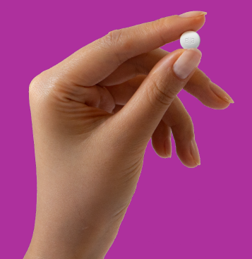 Woman's hand holding a pill