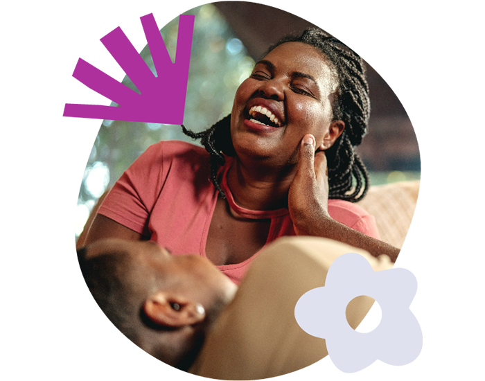 Couple laughing on a couch