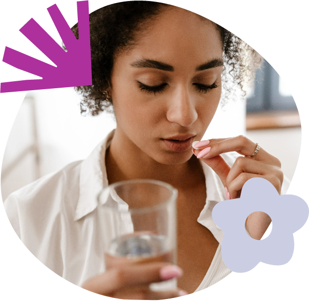 Woman taking a pill with a glass of water