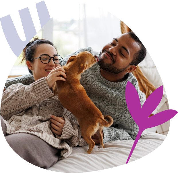 Couple playing with their dog